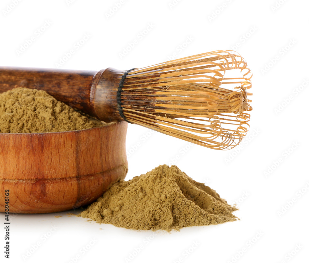 Bowl with hojicha powder and chasen on white background, closeup