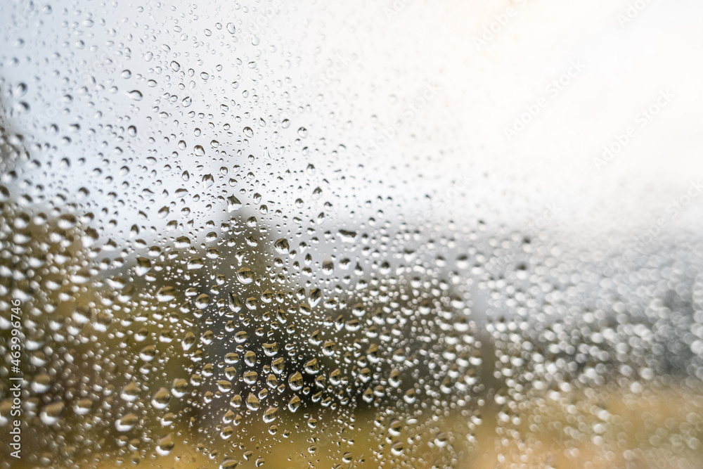 Waterdrops on window glass beginning of autumn