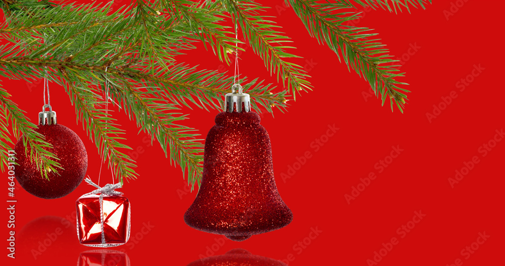 Image of christmas tree decorations over red background