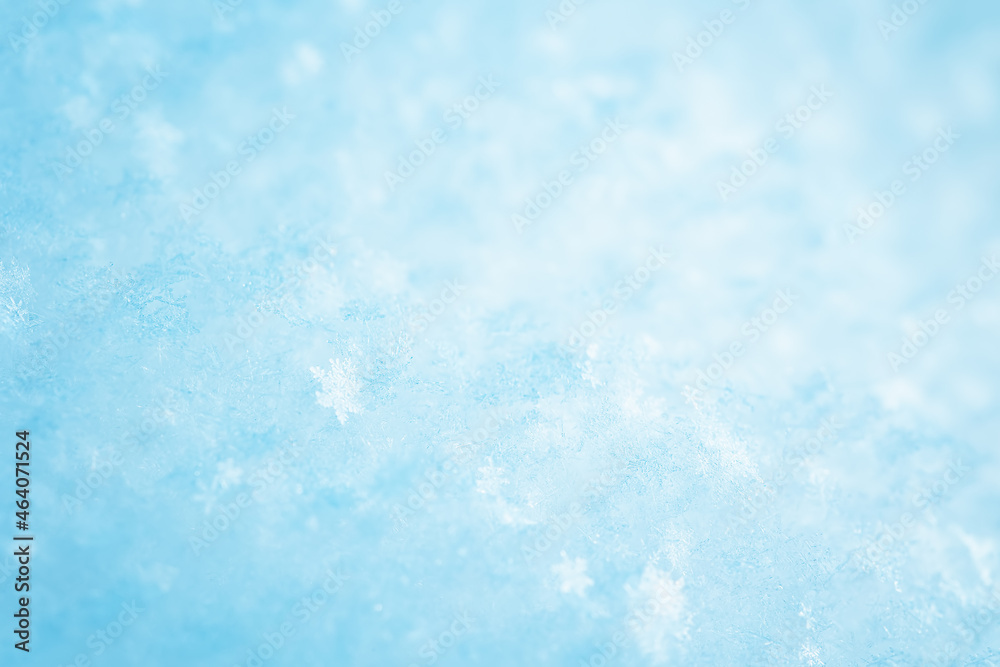 Snowy background with closeup view of the crystal snowflakes