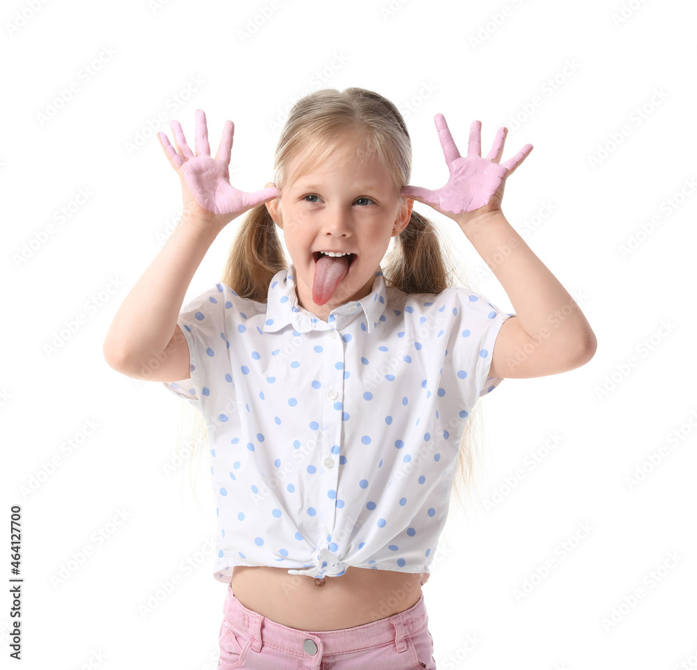 Little girl with hands in pink paint grimacing on white background