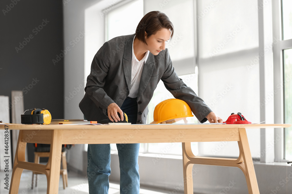 Female industrial engineer working near table in office