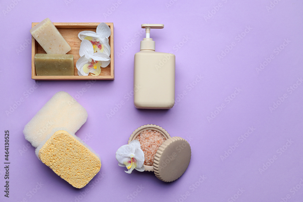 Bath supplies with sponges on color background