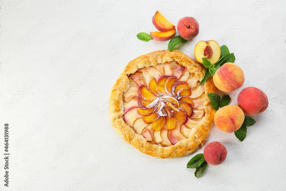 Tasty peach galette on light background