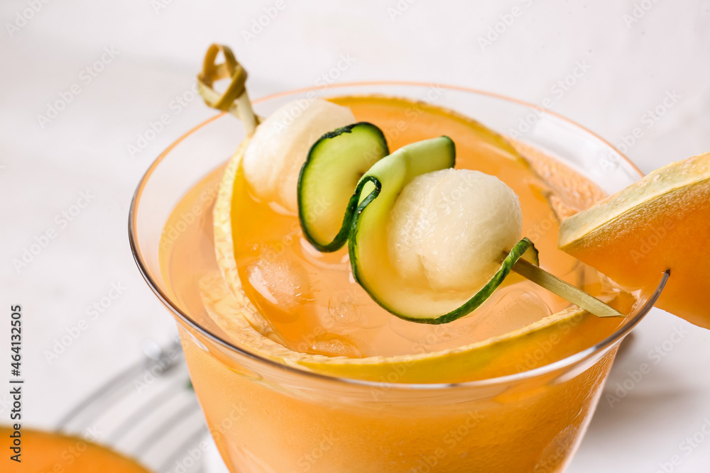 Glass of tasty melon cocktail on light background, closeup