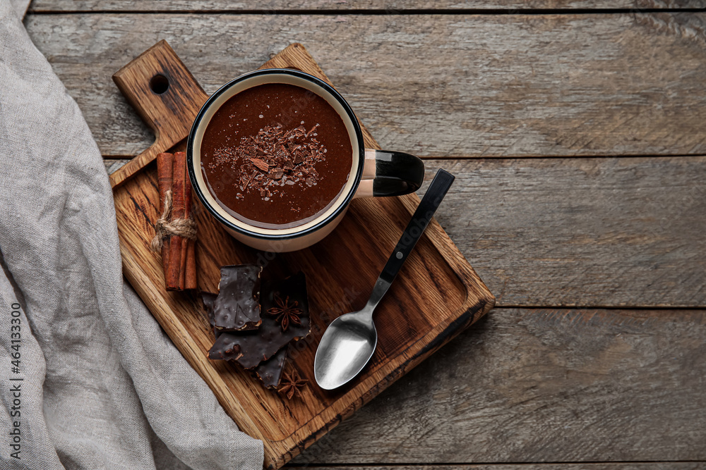 Cup of delicious hot chocolate on wooden background