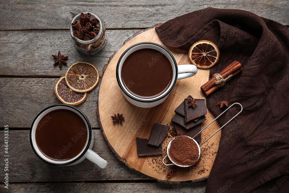 Composition with cups of tasty hot chocolate on wooden background