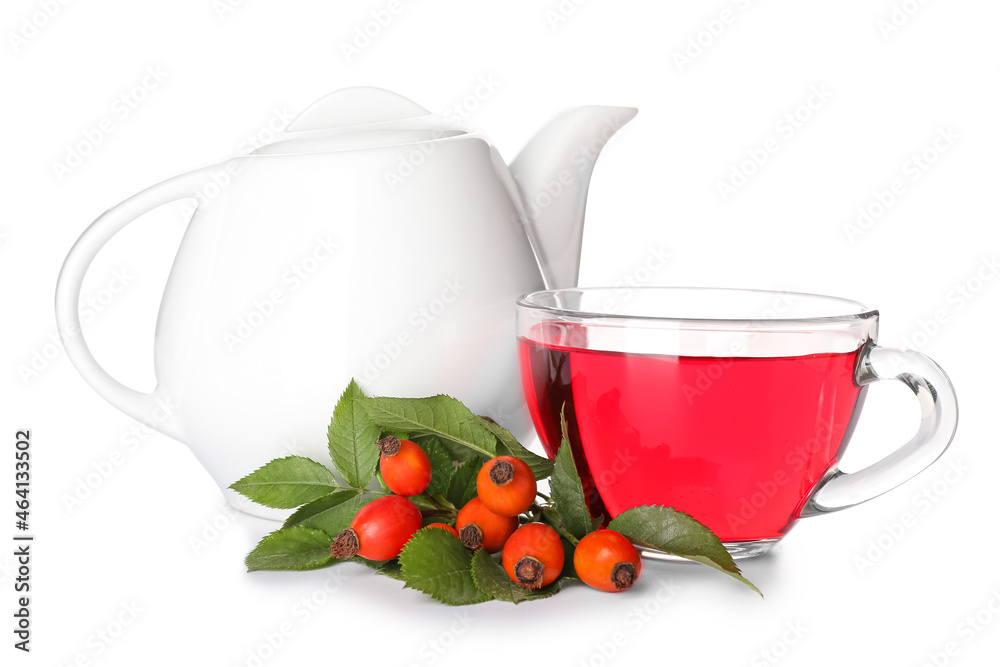 Glass cup tea pot of tasty rose hip beverage and berries on white background