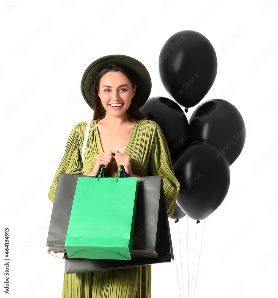 Happy young woman with shopping bags isolated on white. Black Friday sale