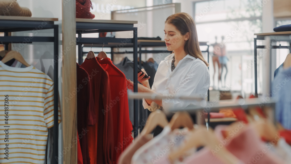 Clothing Store: Businesswoman and Visual Merchandising Specialist Uses Smartphone To Create Stylish 