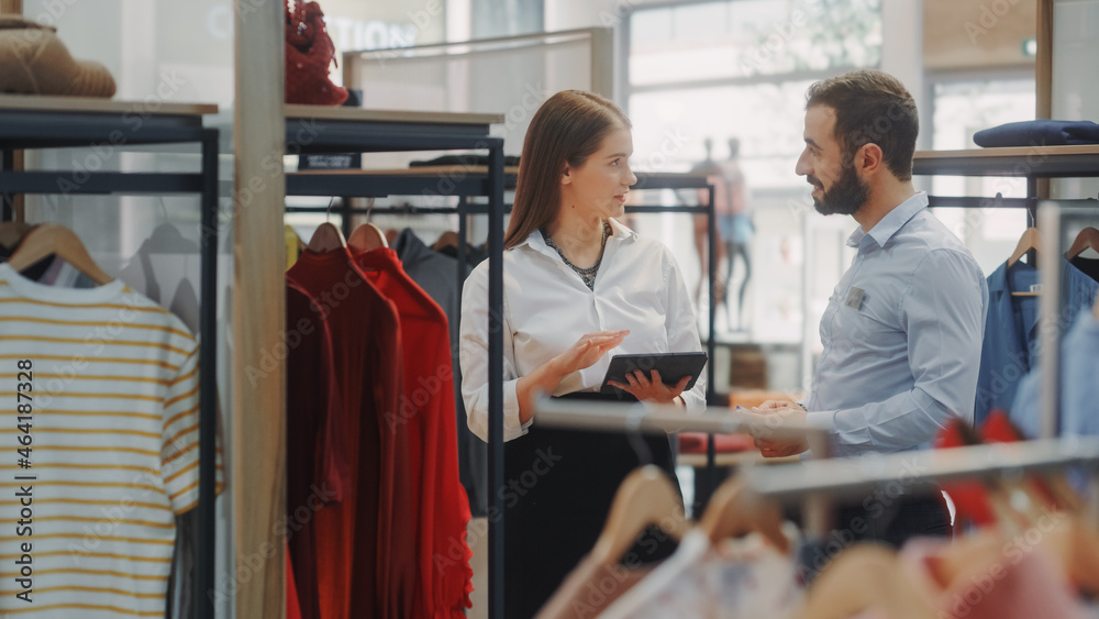 Clothing Store: Businesswoman Uses Tablet Computer, Talks to Visual Merchandising Specialist, Collab