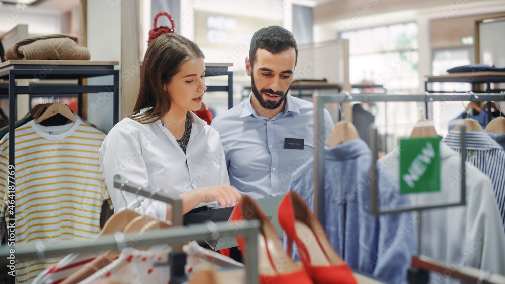 Clothing Store: Visual Merchandiser Talks to Sales Associate, Explains Strategy, Collection Visualiz