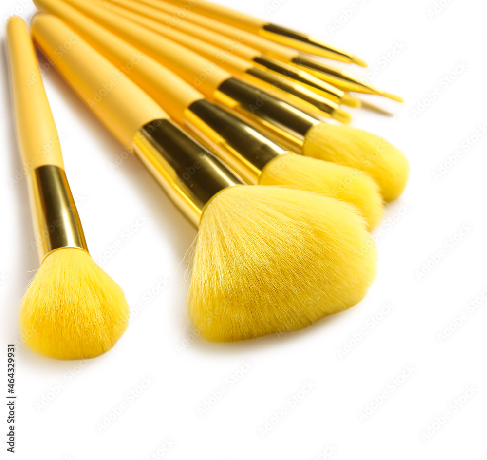 Stylish makeup brushes on white background, closeup