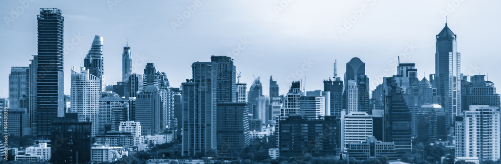 Blue-filtered cityscape and high-rise buildings in metropolis city center . Downtown business distri