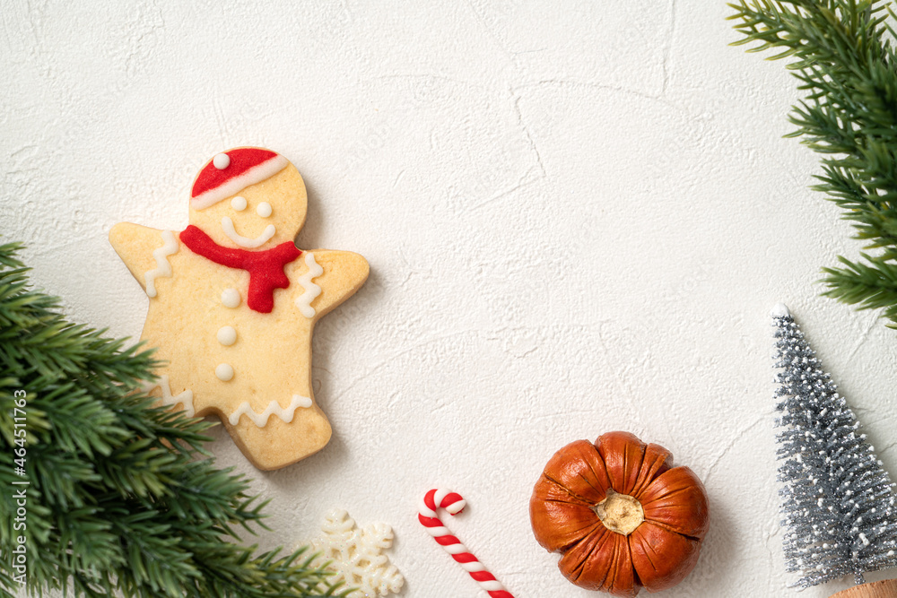 Decorated Christmas gingerbread cookies with decorations on white table background.