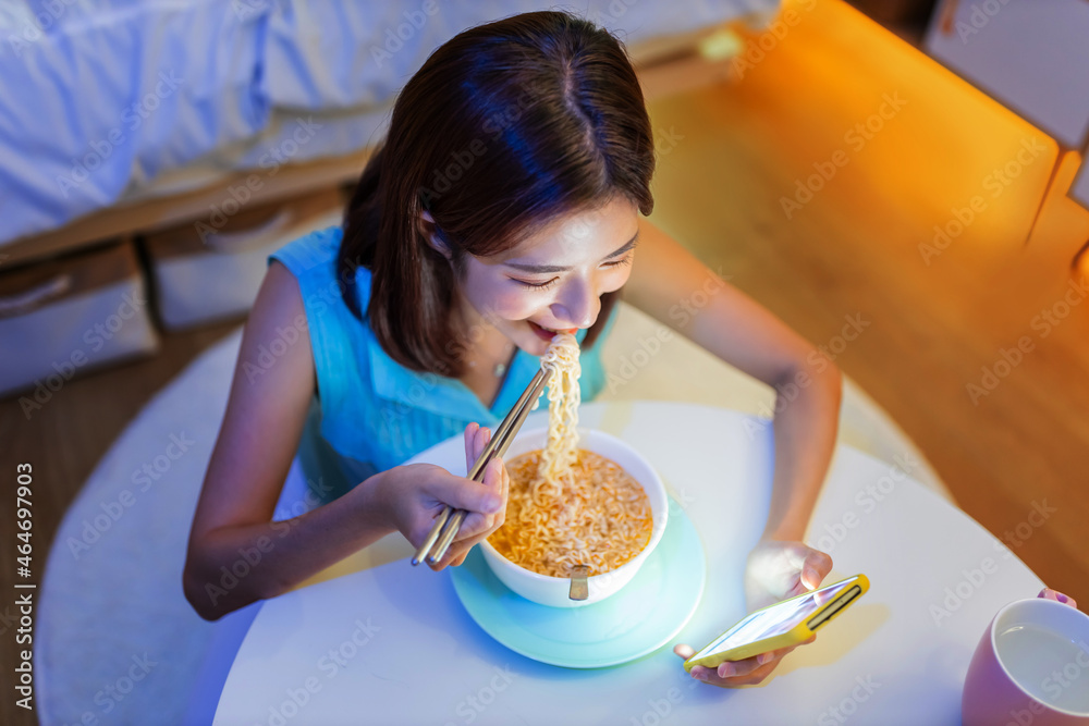 woman eating instant noodles