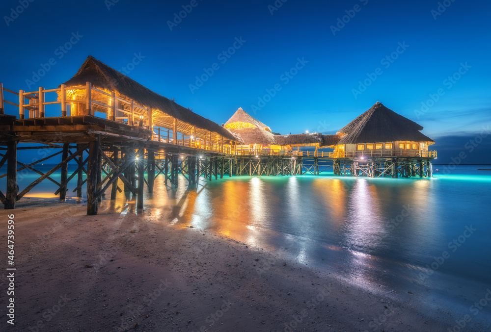 Beautiful wooden restaurant on the water in summer night