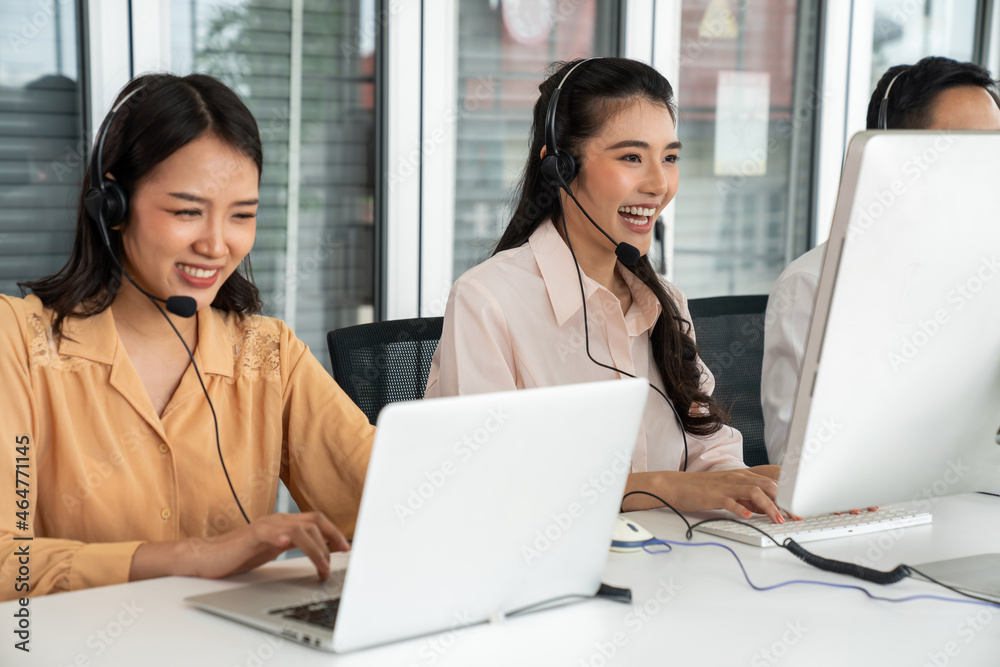 Business people wearing headset working actively in office . Call center, telemarketing, customer su