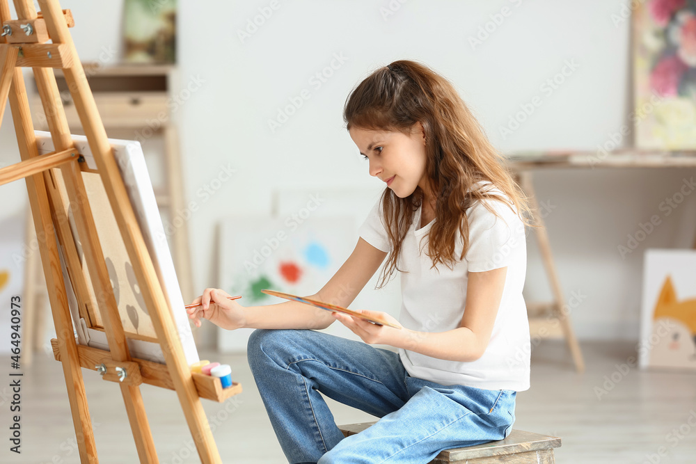 Cute little girl painting at home