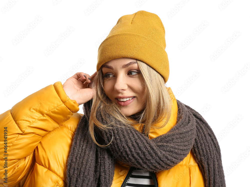 Happy woman wearing warm scarf and hat on white background