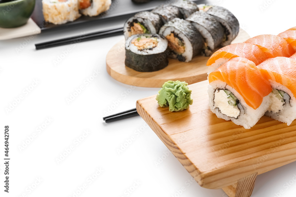 Delicious sushi rolls on white background