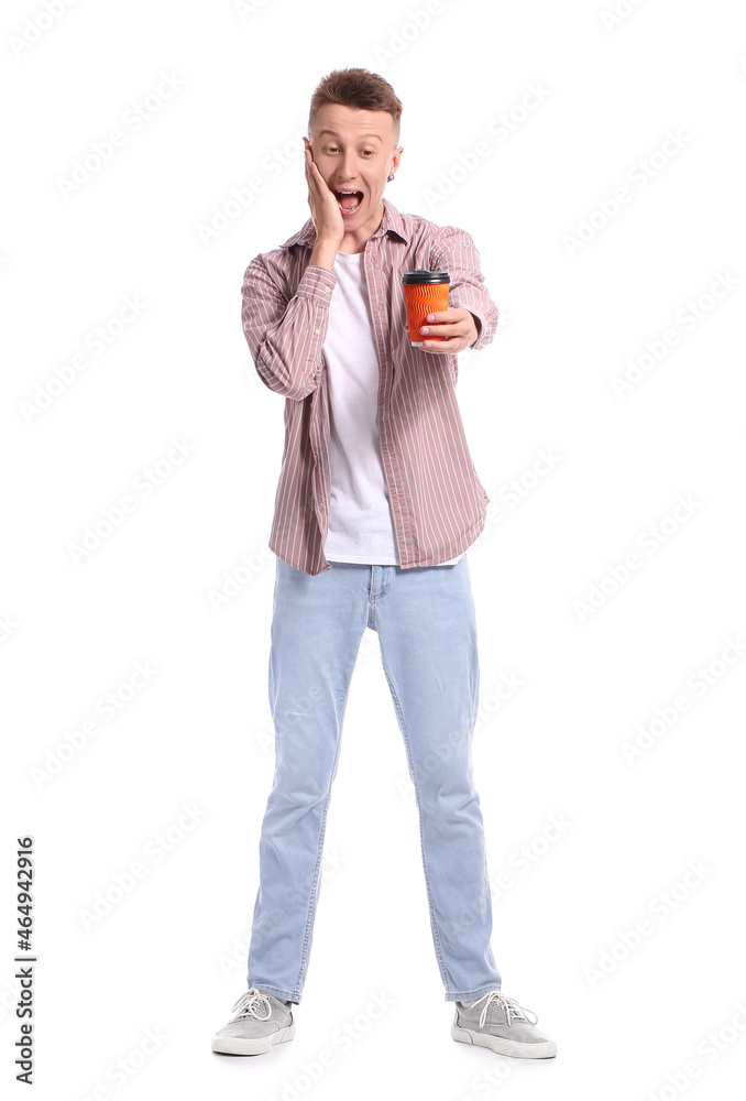 Surprised young man with takeaway cup of coffee on white background