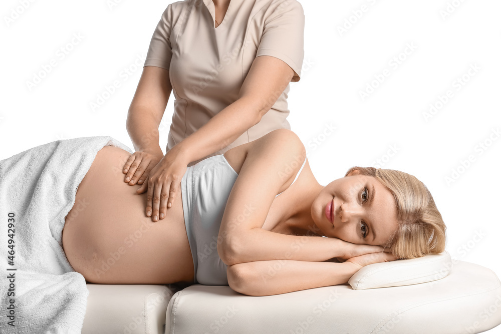 Young pregnant woman having massage against white background