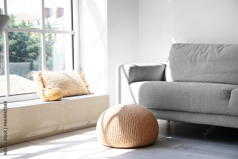 Interior of light living room with pouf