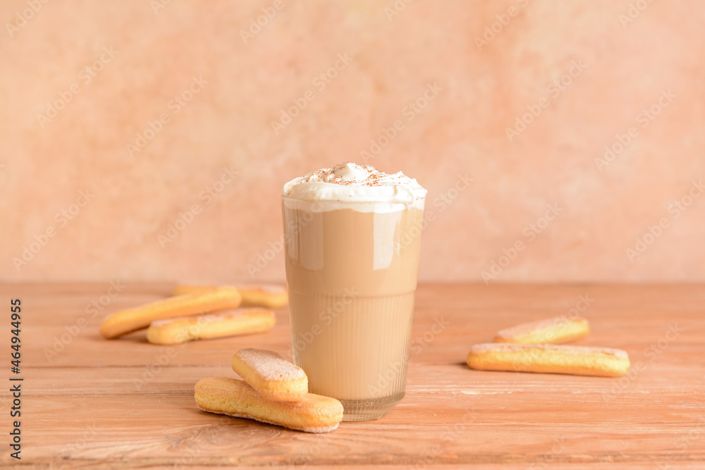 Glass of tasty Tiramisu Latte on table