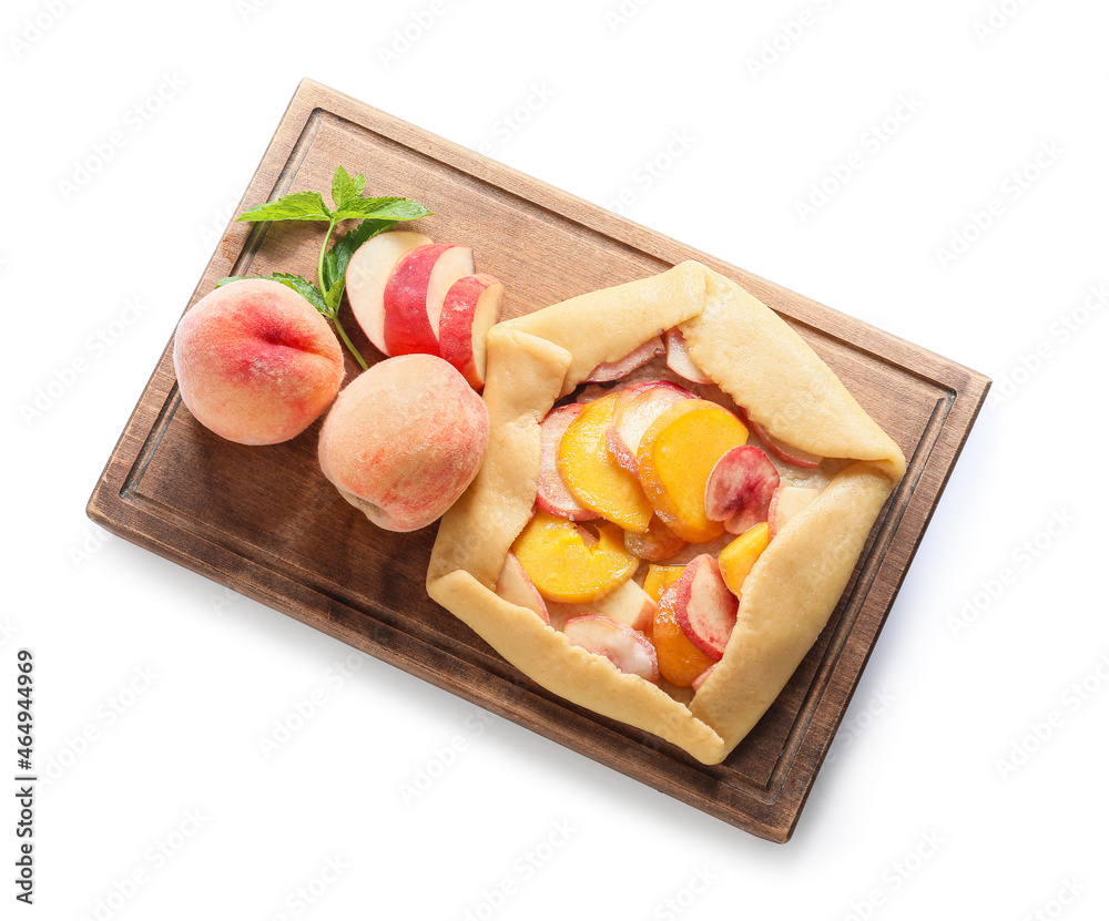 Wooden board with raw peach galette on white background