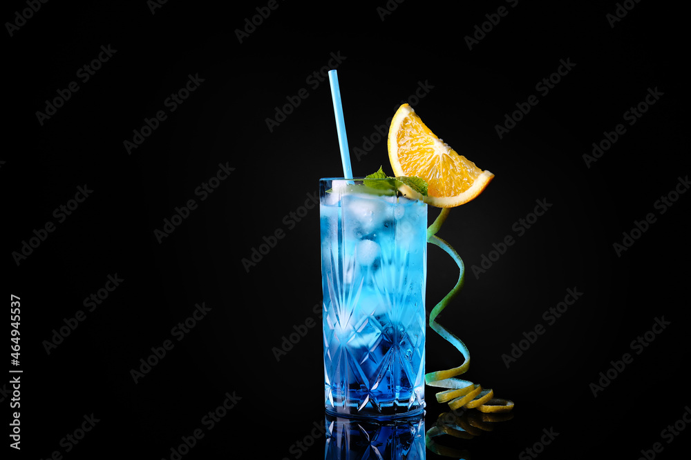 Glass of Blue Lagoon cocktail on dark background