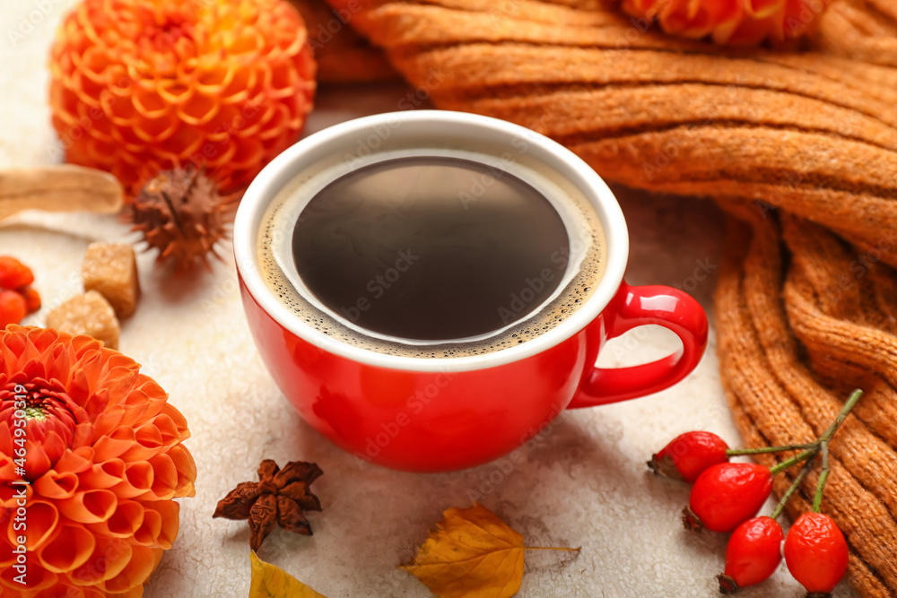 Beautiful autumn composition with cup of coffee, chrysanthemum flower and sweater on light backgroun