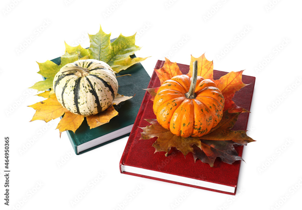 Composition with books, maple leaves and pumpkins on white background