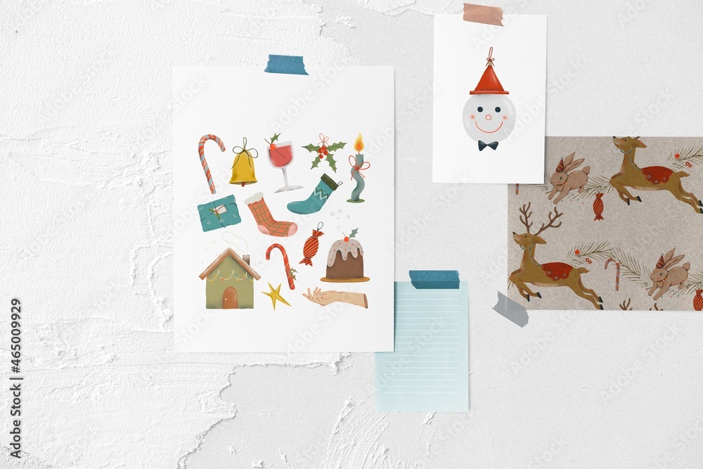 Christmas card papers on white wall, holiday stickers