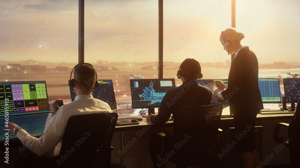 Diverse Air Traffic Control Team Working in a Modern Airport Tower at Sunset. Office Room is Full of