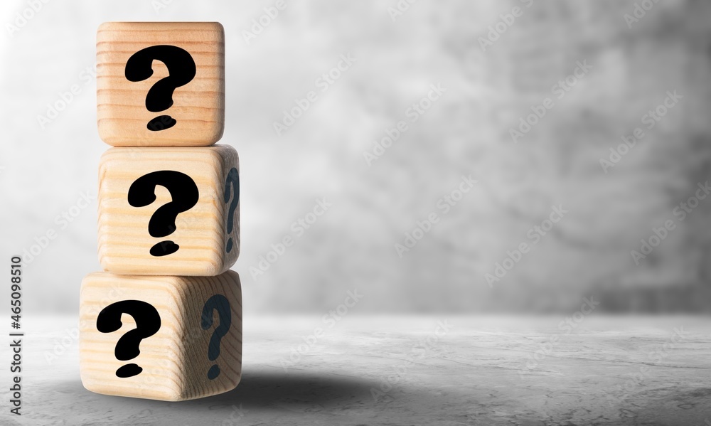 Wooden cubes with question marks on a table.