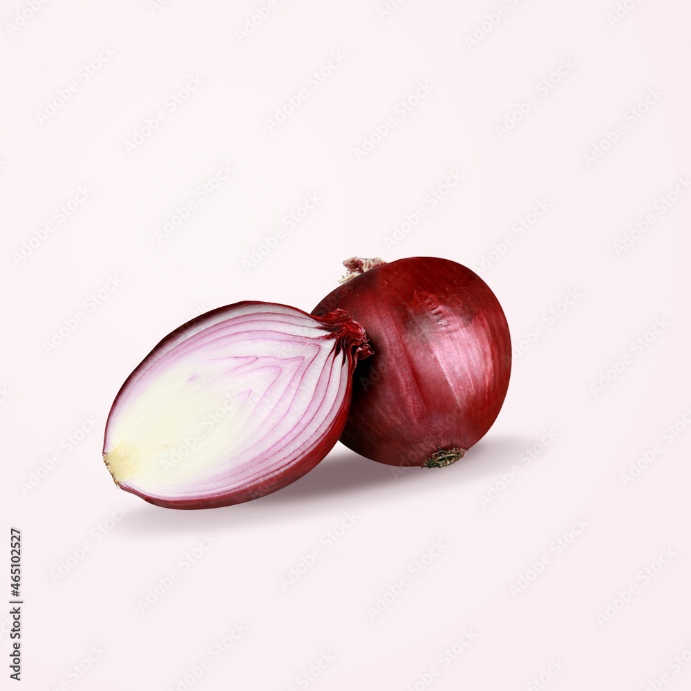 Red whole and sliced onion on the desk