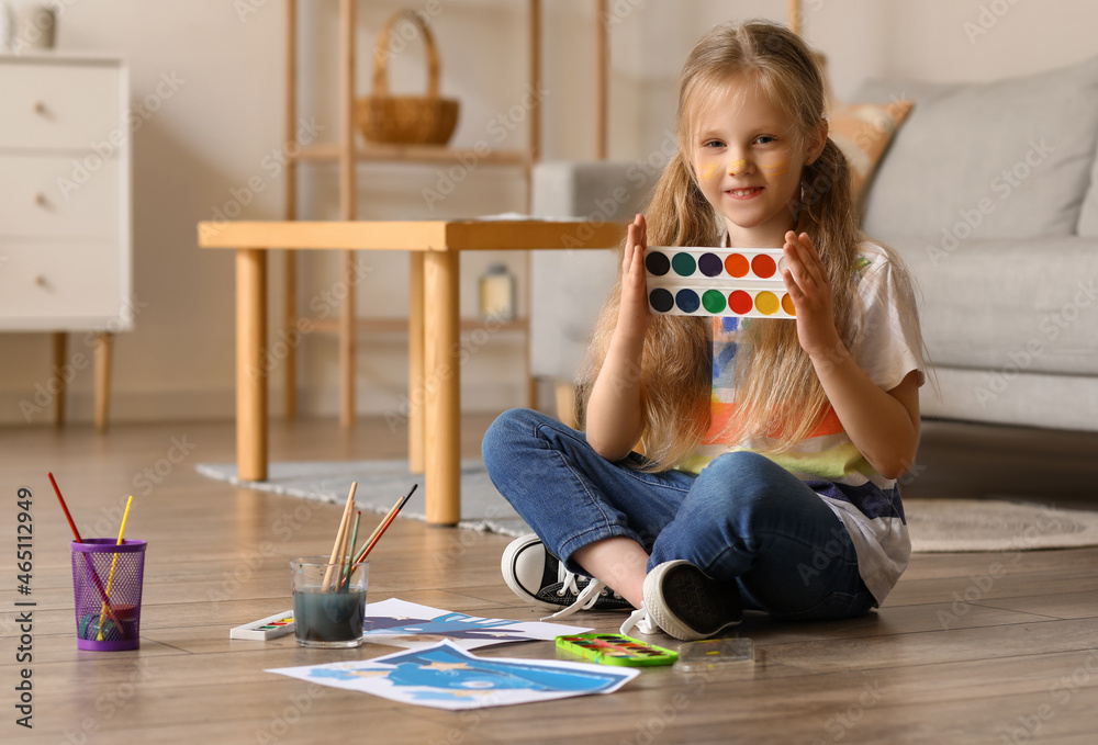 Little girl with watercolors at home