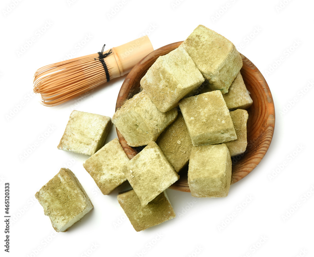 Bowl with tasty hojicha marshmallows and chasen on white background