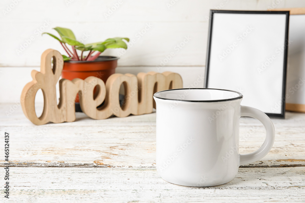 Stylish blank cup on light wooden background