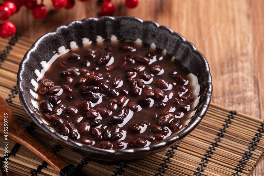 Adzuki red bean soup on wooden table background.