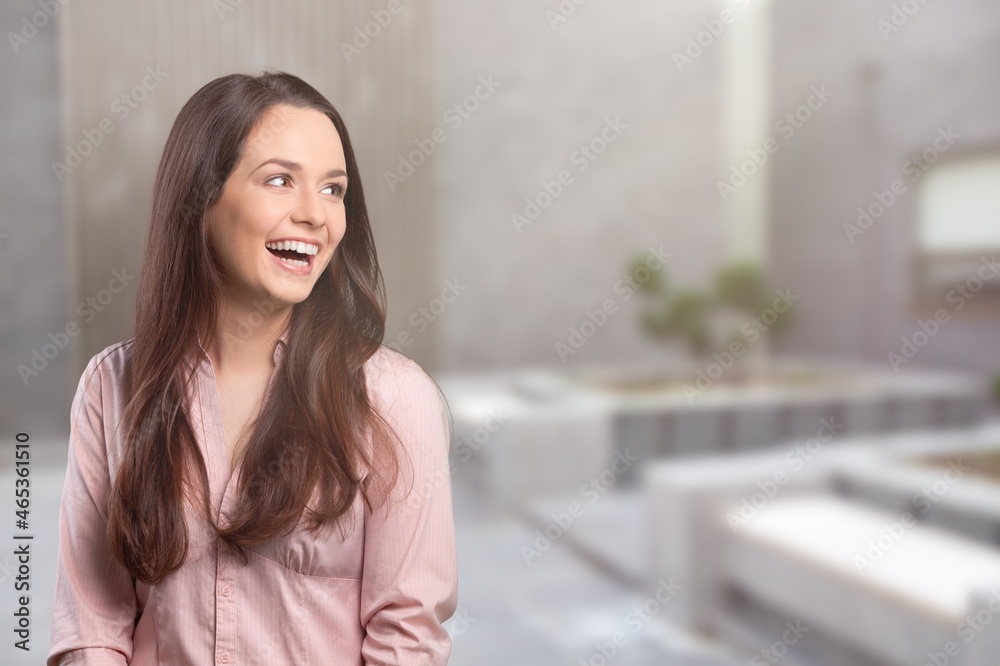 Portrait of a cheerful, adult girl laughing stand on a background