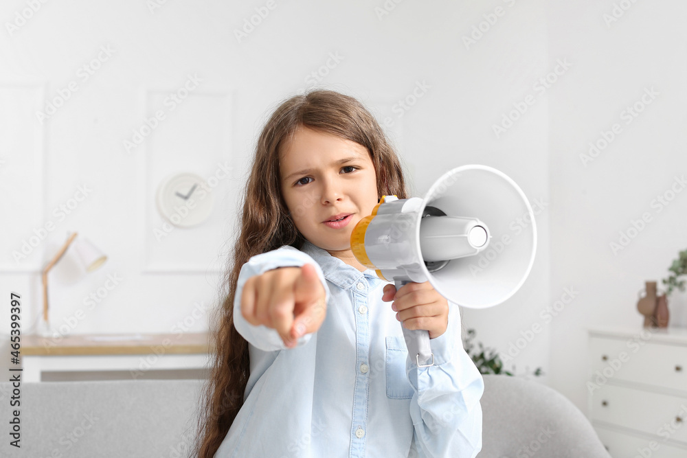 Cute little girl with megaphone at home