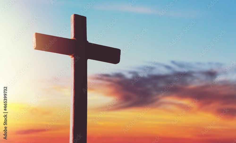 Wooden cross during sunset hour background