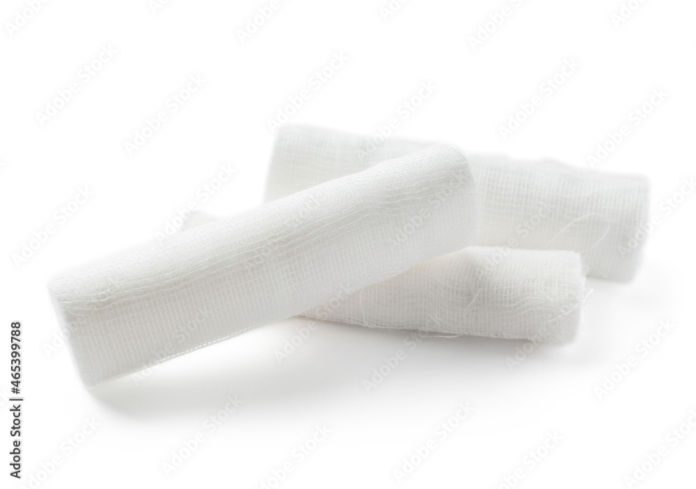 Medical gauze rolls on white background