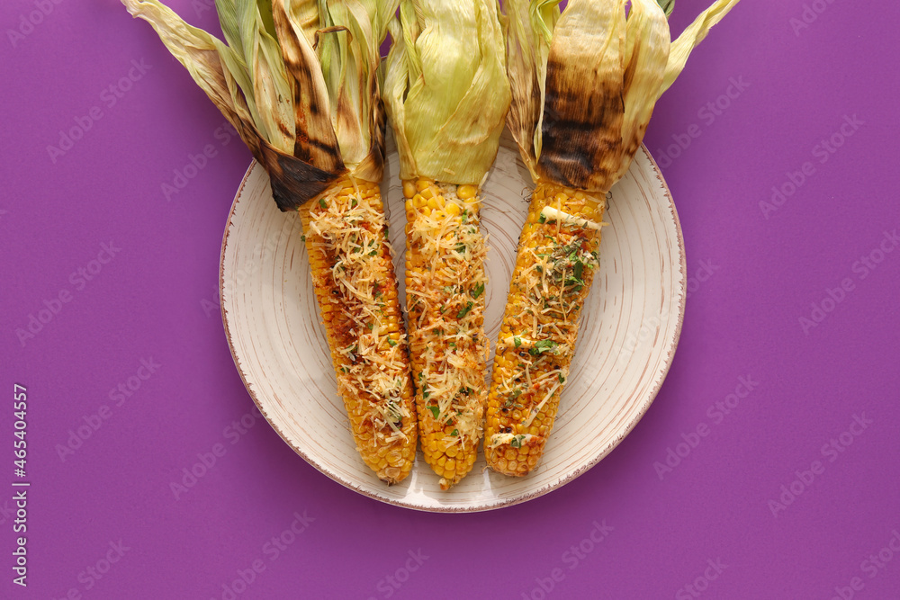 Plate with delicious Elote Mexican Street Corn on purple background