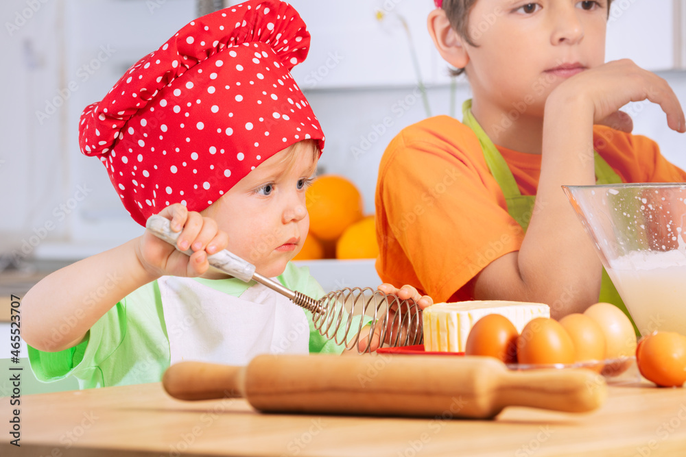 Little boy with whisk cook dough, cookies at home