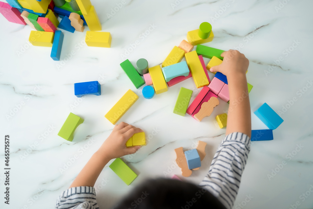 Elementary boy and girl playing on floor with educational toys,Children toddlers at home or daycare,