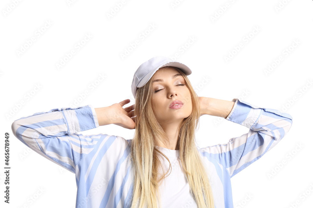 Young woman with closed eyes wearing visor hat and touching her head on white background