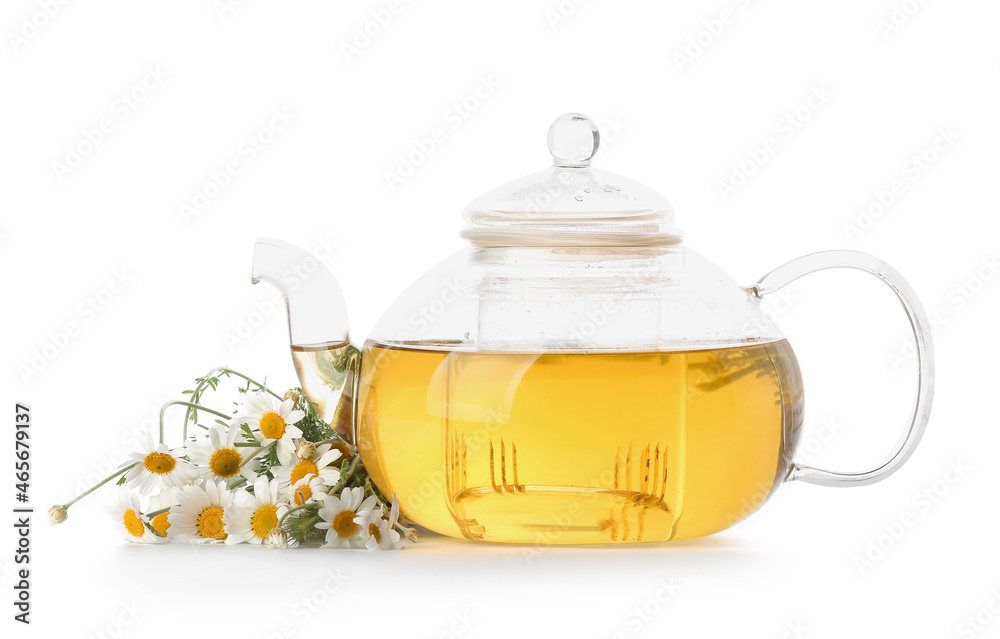 Teapot of tasty tea with chamomile flowers on white background